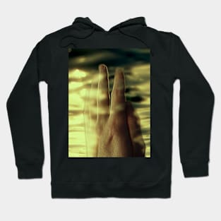 Digital collage and special processing. Hand near soft light. Soft and calm. To exist. Yellow. Hoodie